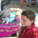 Little boy getting his face painted