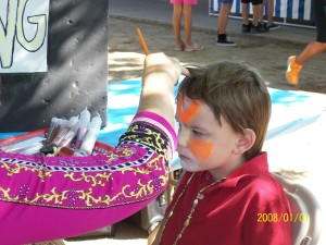 Little boy getting his face painted